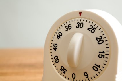 Kitchen timer on wooden counter.